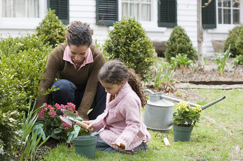  a woman gardening with her daughter