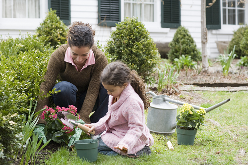 a woman gardening with her daughter
