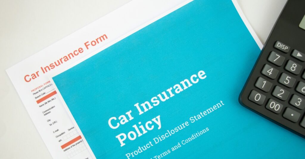 A bright blue document that says, "Car Insurance Policy," sits on top of another document that reads, "Car Insurance Form."